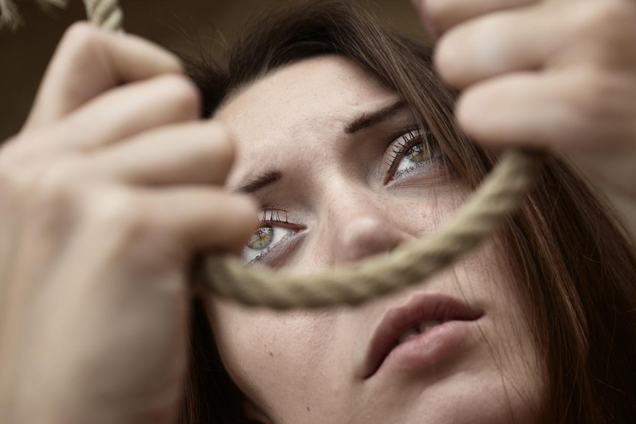 Teenager holding a noose, about to hand herself.